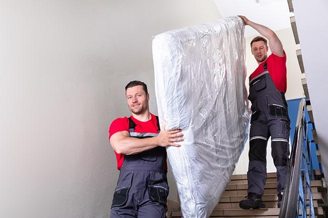 transporting a box spring out of a residential building in Pearlington